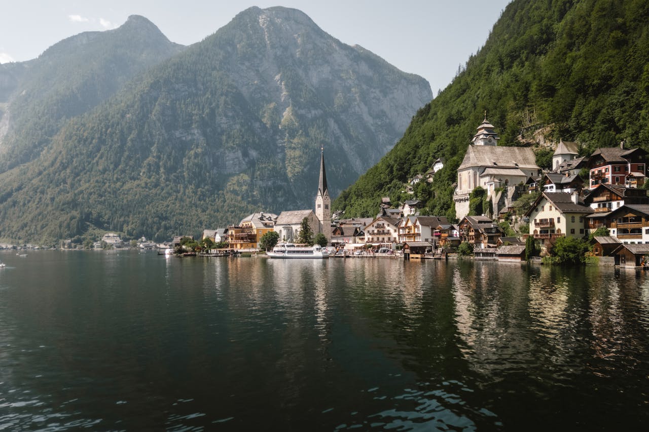 Serene view of Hallstatt village nestled by the lake, with mountains in the background.